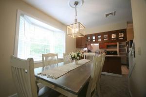 a kitchen with a table with chairs and a dining room at Outdoor Playground on Lake and Close to Skiing in Windsor