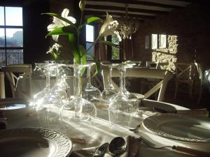a table with wine glasses and flowers on it at Hotel Boutique Real Posada De Liena y Restaurante Liena in Murillo de Gállego