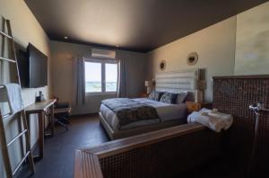 a bedroom with a bed and a desk and a television at Palm Beach in Ajaccio