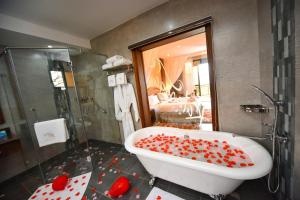 a bathroom with a bath tub covered in red hearts at Kalanoga Resort in Kampala