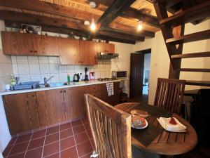 a kitchen with a wooden table and a table and chairs at Arhontiko Askas Mansion in Askas