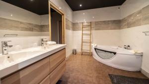 a bathroom with two sinks and a bath tub at Palm Beach in Ajaccio +36 photos
