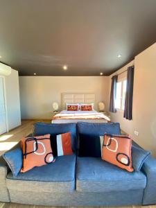 a bedroom with a bed and a blue couch at Palm Beach in Ajaccio
