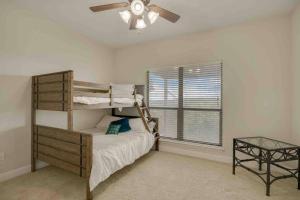 a bedroom with a bunk bed and a ceiling fan at Canyon Lake Home with Breathtaking View in Canyon Lake