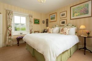 a bedroom with a large bed and a window at Ingram House Bed & Breakfast in Alnwick
