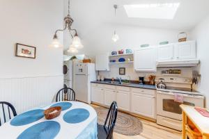 a kitchen with white cabinets and a table and chairs at Day Dreamer in Florence