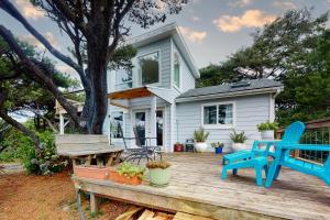 a house with a wooden deck with a blue chair at Day Dreamer in Florence