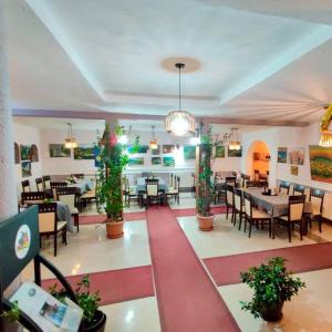 a dining room with tables and chairs in a restaurant at Hotel Rudi in Boge