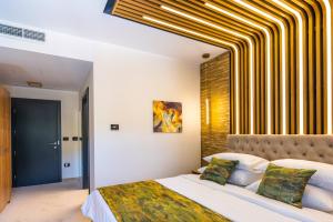 a bedroom with a bed with a yellow and white striped ceiling at Hotel Ivascu in Moisei