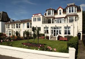 une grande maison blanche avec un jardin en face de celle-ci dans l'établissement SGE Esplanade Hotel, à Dunoon