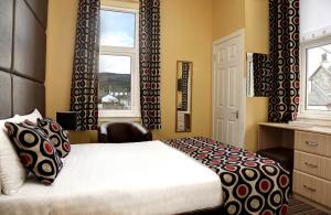 A bed or beds in a room at SGE Esplanade Hotel