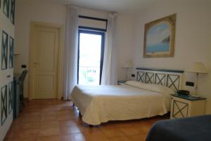 A bed or beds in a room at Hotel Club Sabbiadoro