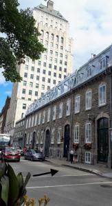 a large building on a street with a building at Condo de Lux Le Méribel du Vieux-Québec in Quebec City