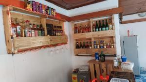 a bar with bottles of alcohol on the wall at Feel At Home & be close to the Labadi Beach (5min) in Accra