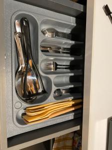 a drawer filled with utensils in a cabinet at Apartment X Palm Village Mikocheni in Dar es Salaam