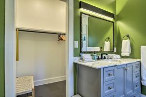 a bathroom with a sink and a mirror at Renovated Carrboro House with Deck and Fire Pit! in Carrboro +26 photos