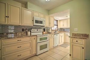 a kitchen with white cabinets and white appliances at Caryville Home with Dock, Steps to Norris Lake! in Caryville