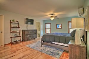 een slaapkamer met een bed, een dressoir en een televisie bij Caryville Home with Dock, Steps to Norris Lake! in Caryville