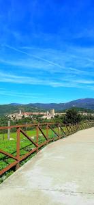a wooden fence on the side of a road at La Dueña I in Miranda del Castañar