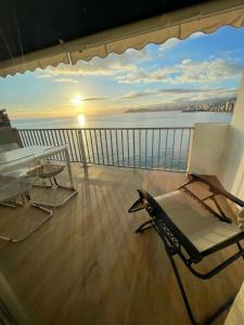 balkon ze stołem i krzesłem na statku w obiekcie Portofino Mar y Sal w mieście Benidorm