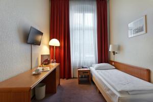 Postel nebo postele na pokoji v ubytování acom-Hotel Berlin Kurfürstendamm