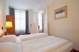 Postel nebo postele na pokoji v ubytování acom-Hotel Berlin Kurfürstendamm