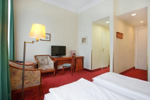 TV a/nebo společenská místnost v ubytování acom-Hotel Berlin Kurfürstendamm