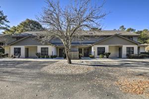 a house with a tree in the driveway at Resort Condo about 2 Mi to Sunset Beach Seashore! in Sunset Beach