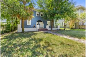 a blue house with a yard with trees at Impressive Cozy Historic 2BR Apt Near Downtown in San Antonio