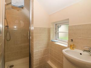a bathroom with a shower and a sink at Hope Cottage in Castleton +13 photos