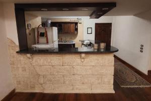 a kitchen with a counter top in a room at Bright spacious apartment in Madīnat ash Shurūq
