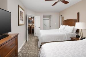 a hotel room with two beds and a flat screen tv at Staybridge Suites North Charleston, an IHG Hotel in Charleston