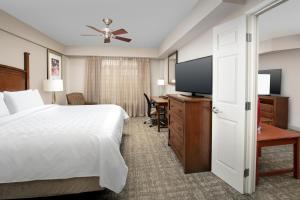 a hotel room with a bed and a flat screen tv at Staybridge Suites North Charleston, an IHG Hotel in Charleston