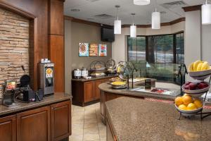 a kitchen with a counter with fruit on it at Staybridge Suites North Charleston by IHG in Charleston