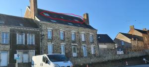 a white van parked in front of a brick building at Apparthotel loft Martigné-Ferchaud in Martigné-Ferchaud