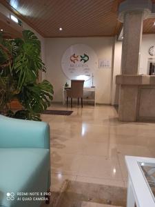 a lobby of a hospital with a chair and a table at Bellavista Avenida By BeGuest in Albufeira
