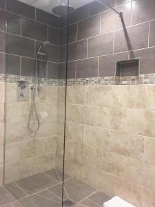 a shower with a glass door in a bathroom at The Kyrenia in Weston-super-Mare