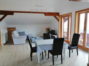 a living room with a table and chairs and a couch at Bella Vista Lodge in Kartitsch