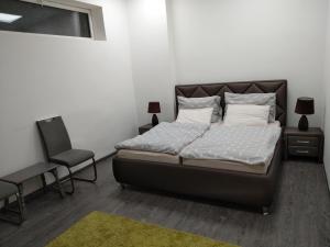 A bed or beds in a room at Silver Dream Apartman