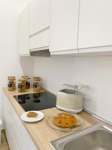 a kitchen with a counter top with a pie on it at B&B La Locanda Chic in Grosseto