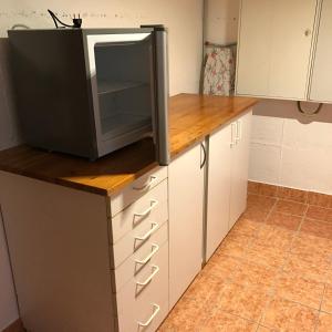 a kitchen with a tv on top of a counter at Haus Wald und Wiese Wohnung Wald in Ehndorf