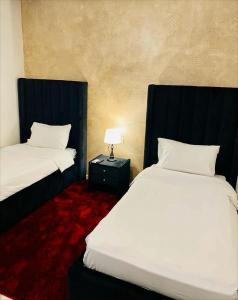 Postel nebo postele na pokoji v ubytování Aparthotel & Hotel Doha