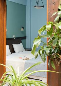 a bedroom with a bed with a blue wall at Dimosthenis in Goumenissa