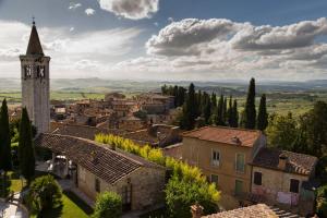 a view of a village with a clock tower at Castello Delle Serre in Rapolano Terme