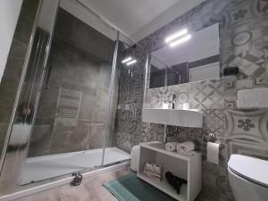 y baño con ducha, aseo y lavamanos. en PincoPancoRooms, en Acquasanta Terme