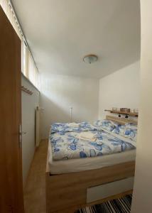 a bedroom with a bed with a blue comforter at Penthousewohnung Gasteinblick in Bad Gastein