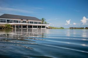 a building on the shore of a body of water at Altos del Arapey All Inclusive, Golf & Spa in Termas del Arapey