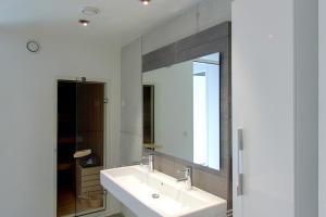 a bathroom with two sinks and a large mirror at Villa Vink in Hollum +26 photos