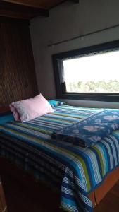 سرير أو أسرّة في غرفة في Casa los Lobos a una cuadra de la playa El Quisco