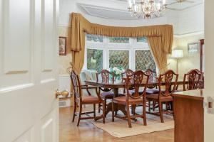 a dining room with a table and chairs and a window at Blackpool Abode - Southlands in Blackpool